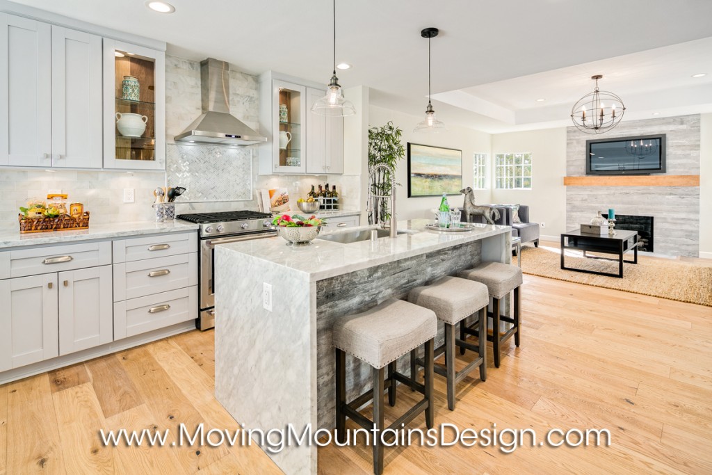 Open plan kitchen home staging with barstools and marble counter